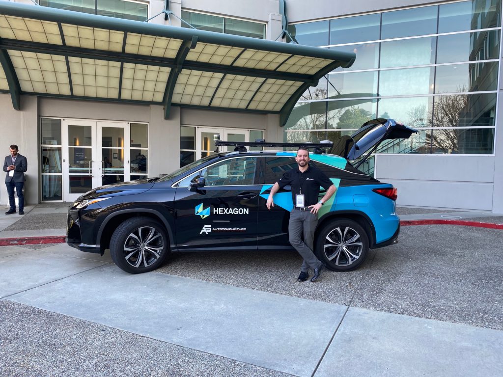 Photograph of Hexagon | AutonomouStuff branded Lexus with trunk open and man standing next to it
